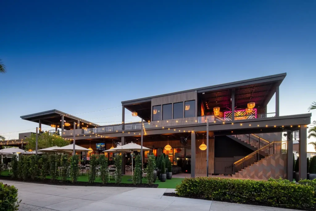 Exterior of Tap 42 Fort Myers at dusk with its second-floor rooftop