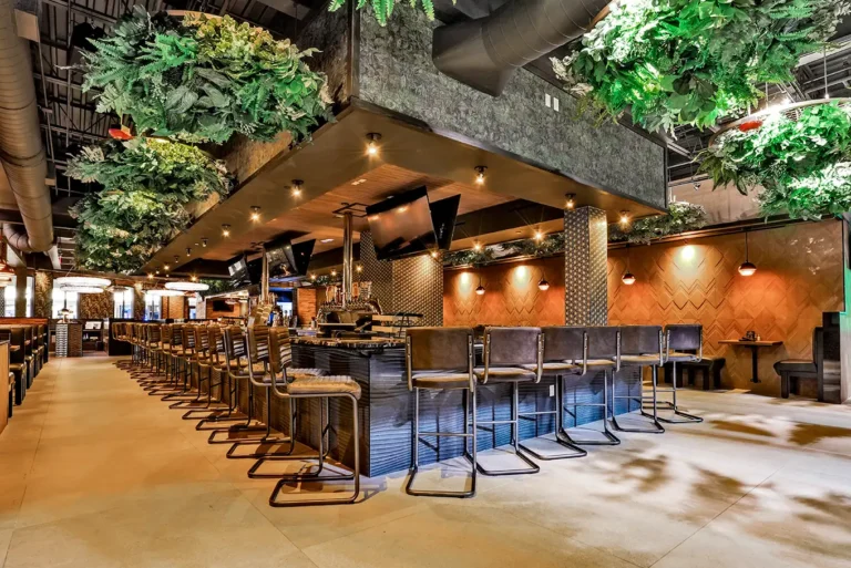 Bar and dining room with hanging greenery at Tap 42 Palm Beach Gardens