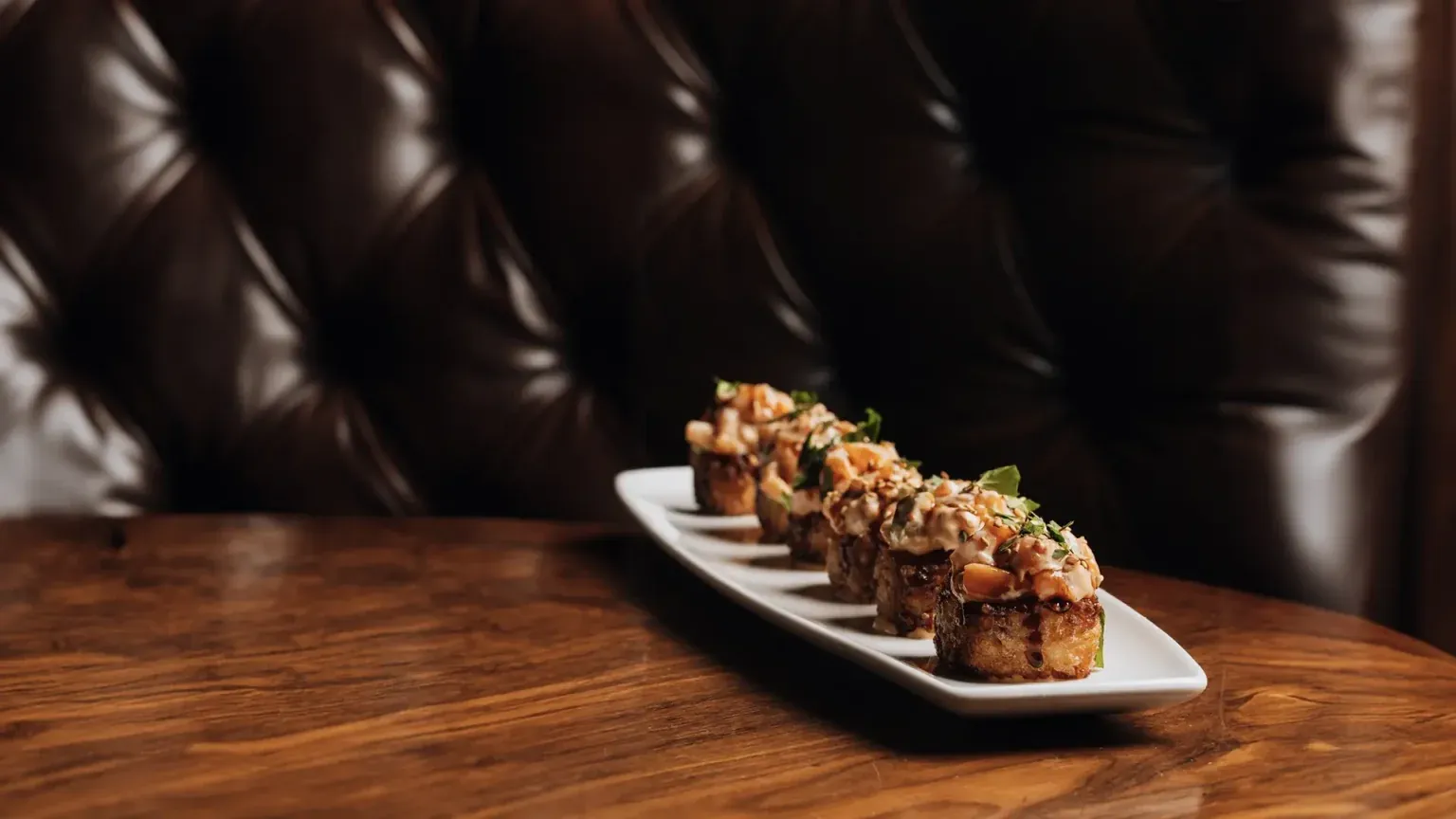 Sushi rolls plated on a wooden table
